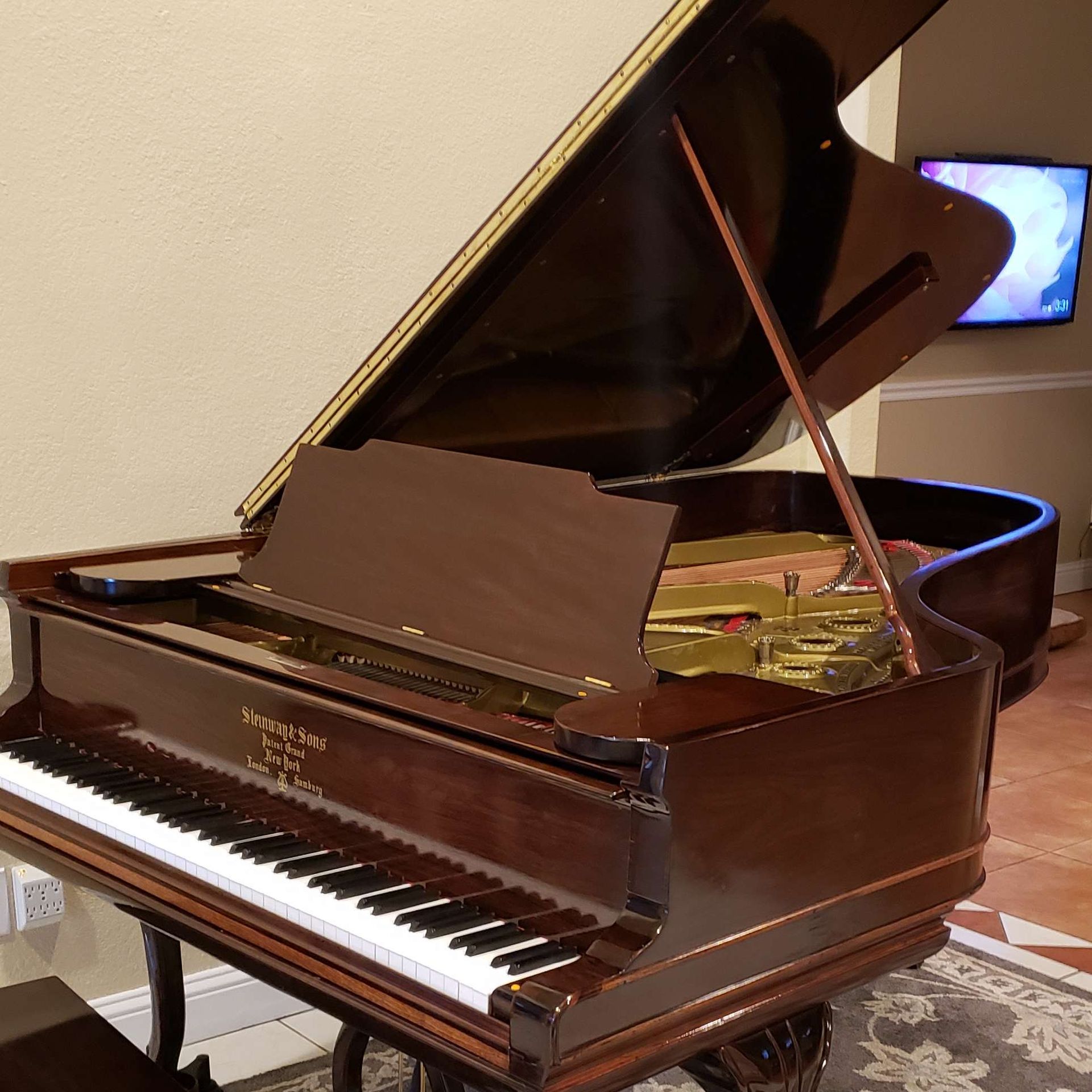 A grand piano with the lid open in a living room