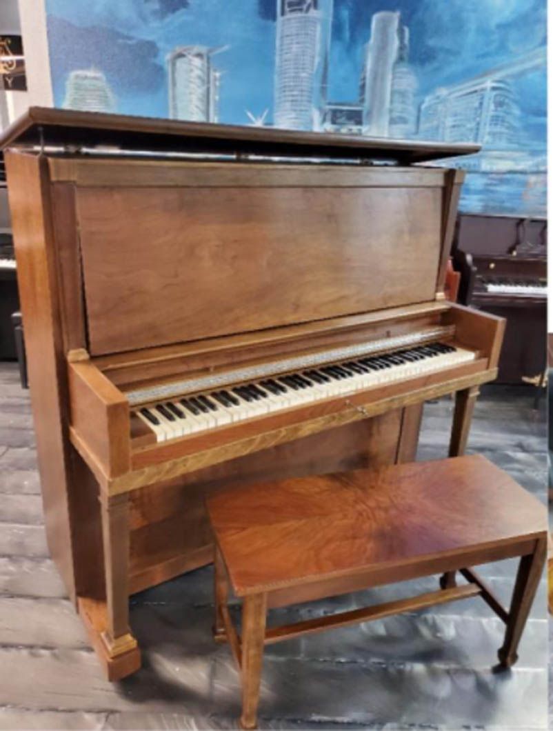 A wooden upright piano with a bench next to it