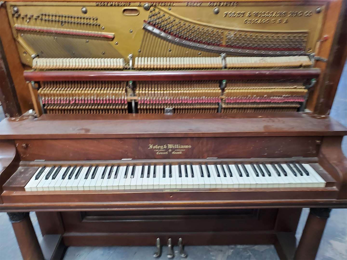 The inside of a piano with the keys visible