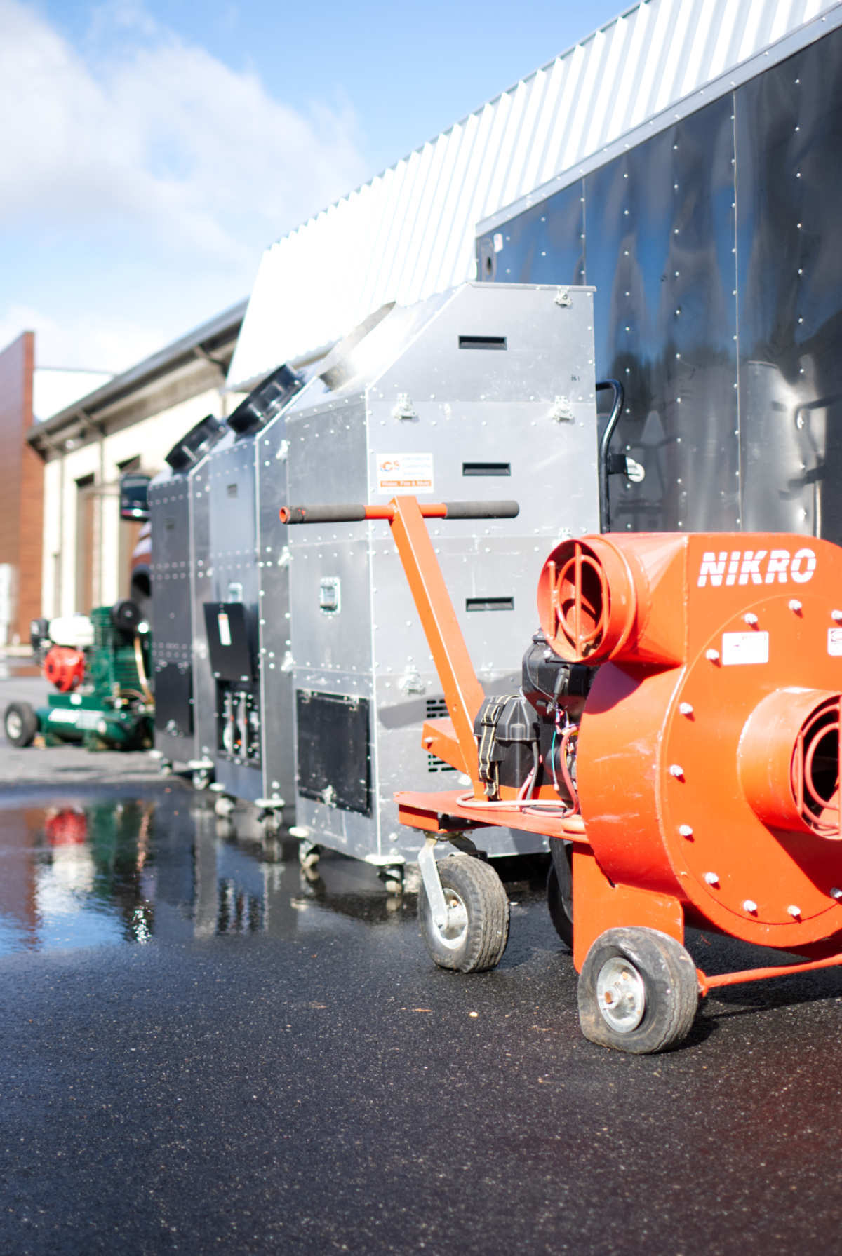 A row of mikro heaters are parked in front of a building