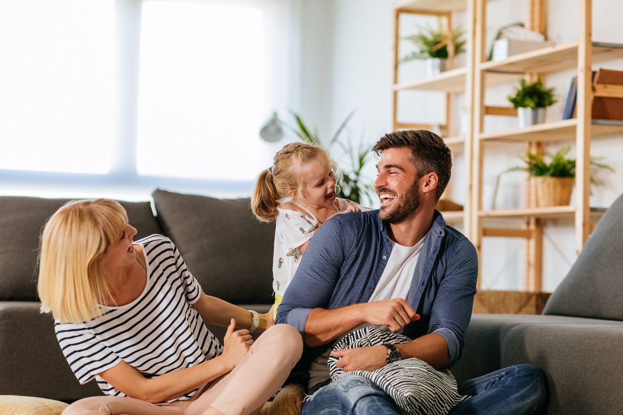 A happy family enjoying a clean home, a concept of proper maintenance of home air ducts.