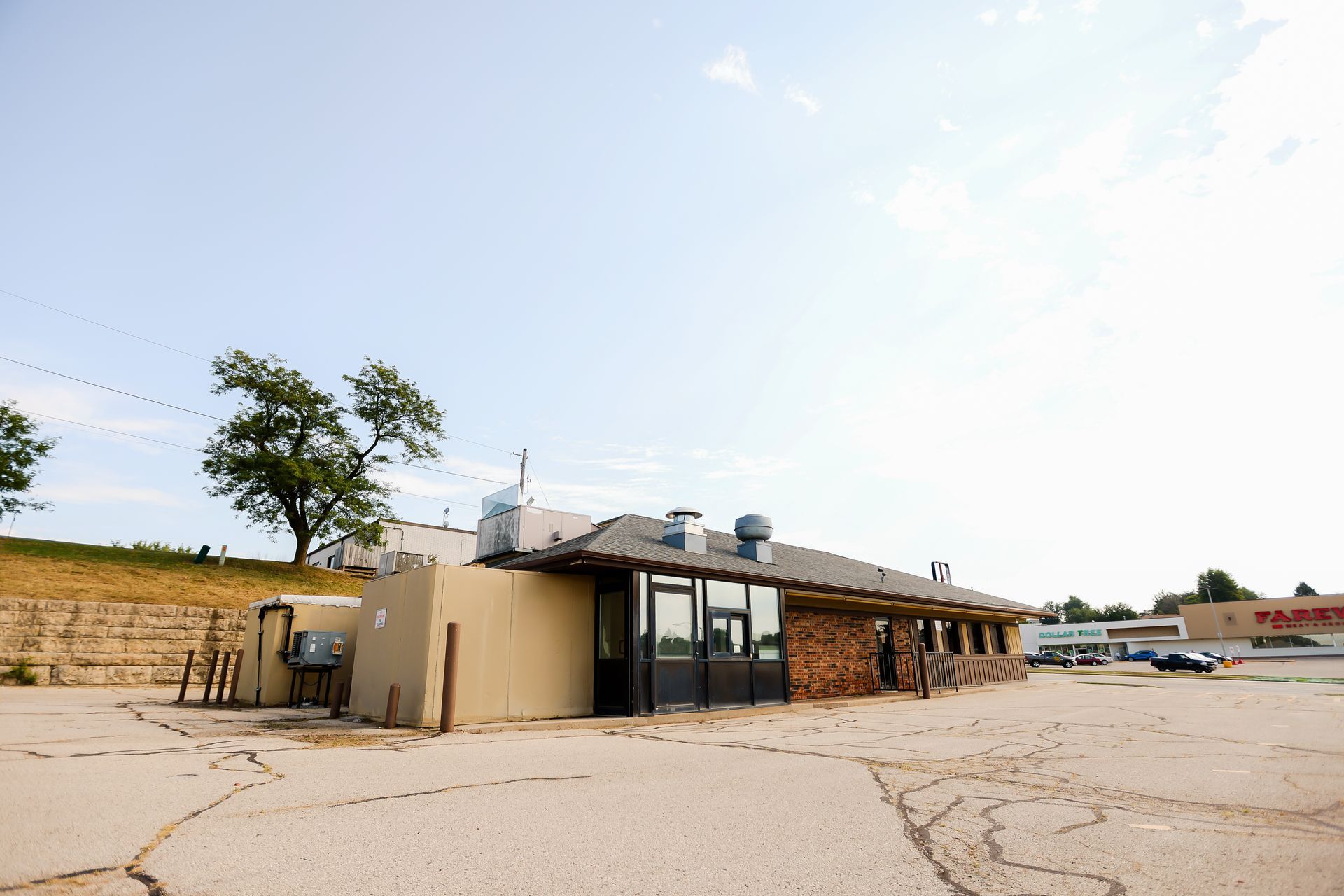 An empty parking lot with a building in the background