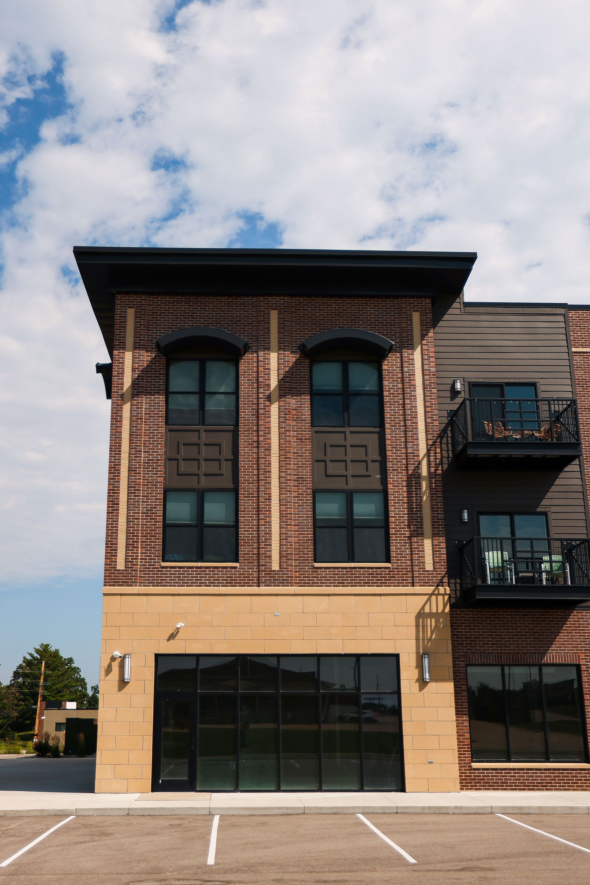 A large brick building with a parking lot in front of it