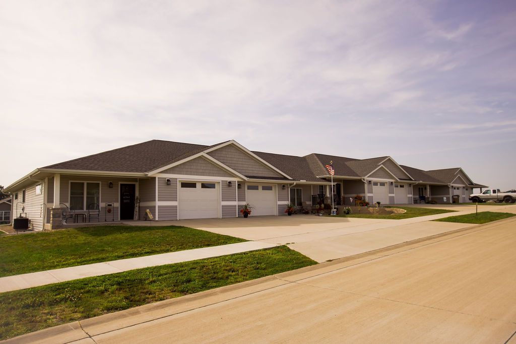 A row of houses are lined up on a dirt road