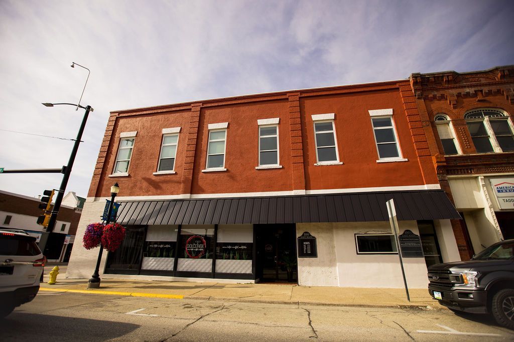 A brick building with a black awning on the side of it