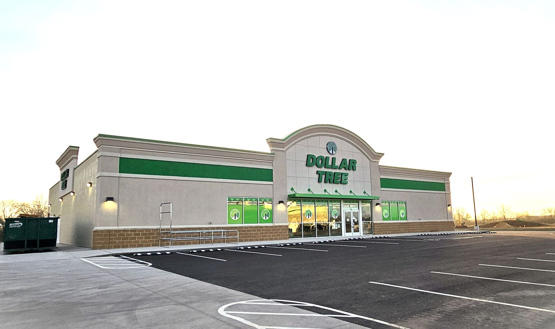 A dollar tree store with a parking lot in front of it