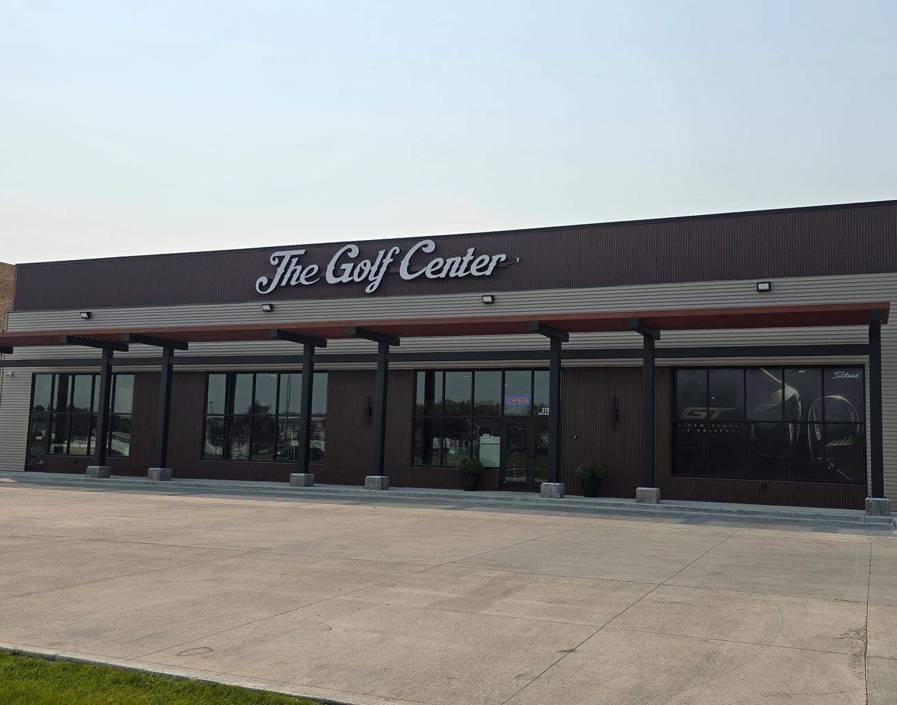 The golf center is a large building with a lot of windows