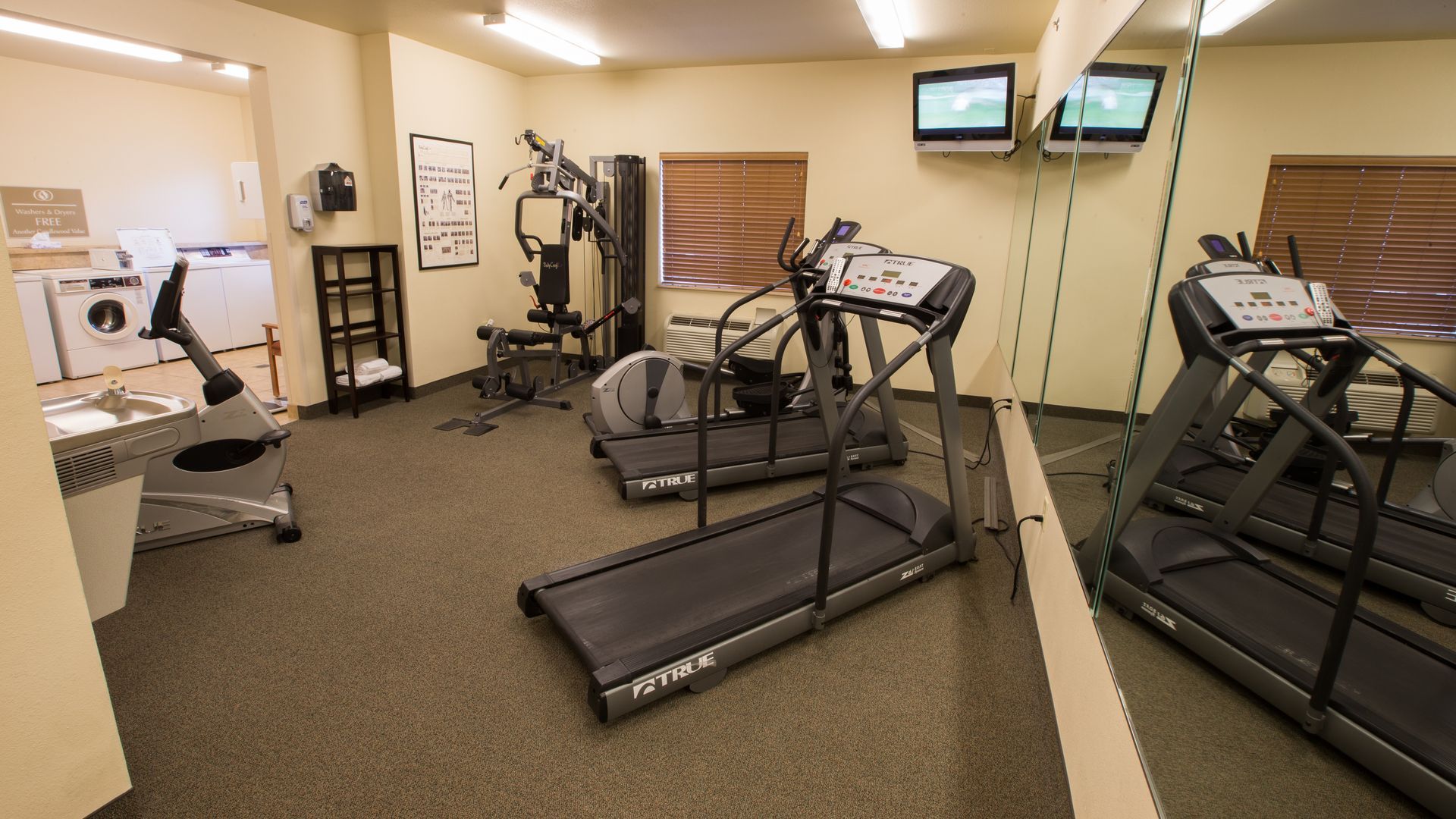24-hour fitness center with cardio equipment and free weights