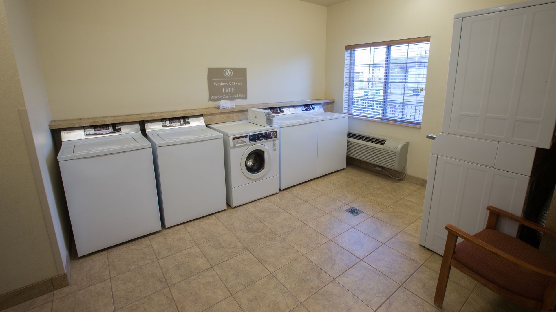 Clean and bright guest laundry room with washers and dryers