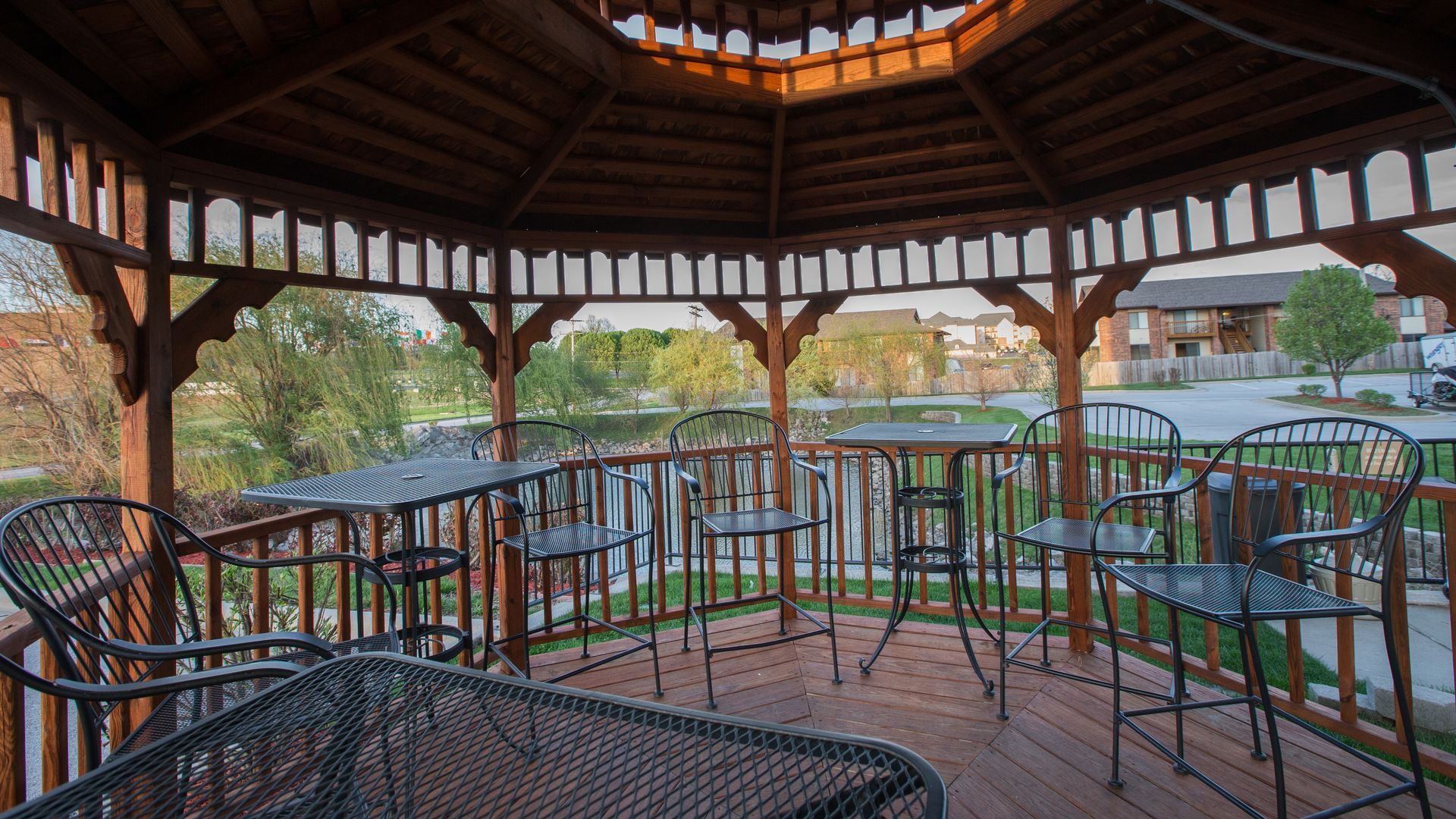 Outdoor BBQ and picnic area with guests gathered around the grill