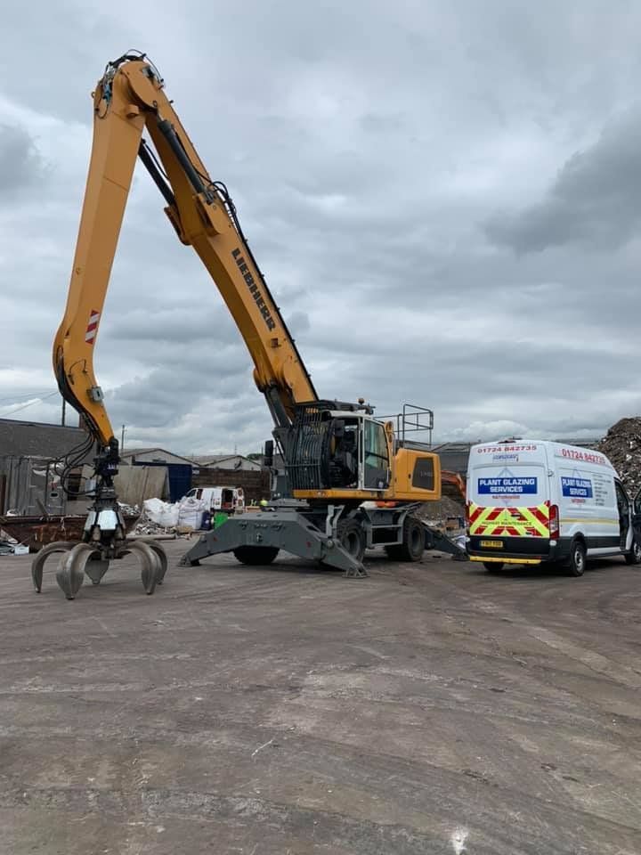 A 1 Motorway Windscreens Ltd van next to a big grabber vehicle