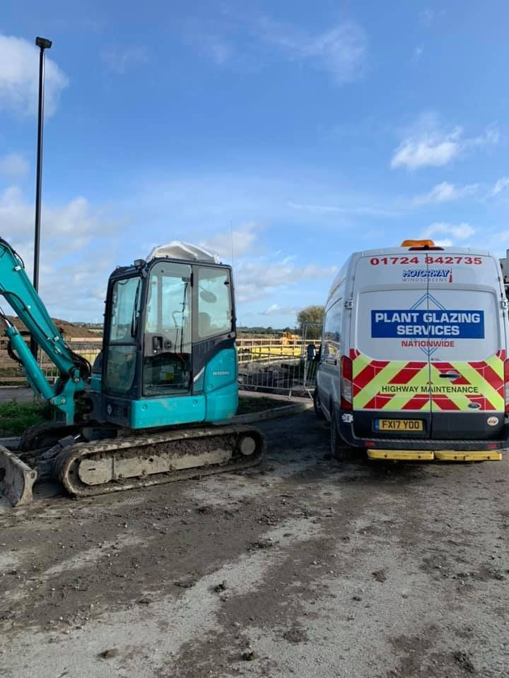 A 1 Motorway Windscreens Ltd van next to a small crane