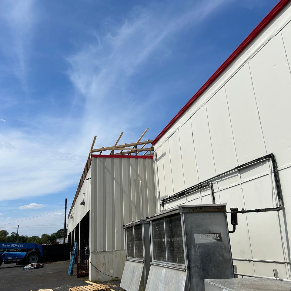 Nolan Construction adding a new sloped truss roof to an existing flat roof for a customer load out area in Richmond, KY.