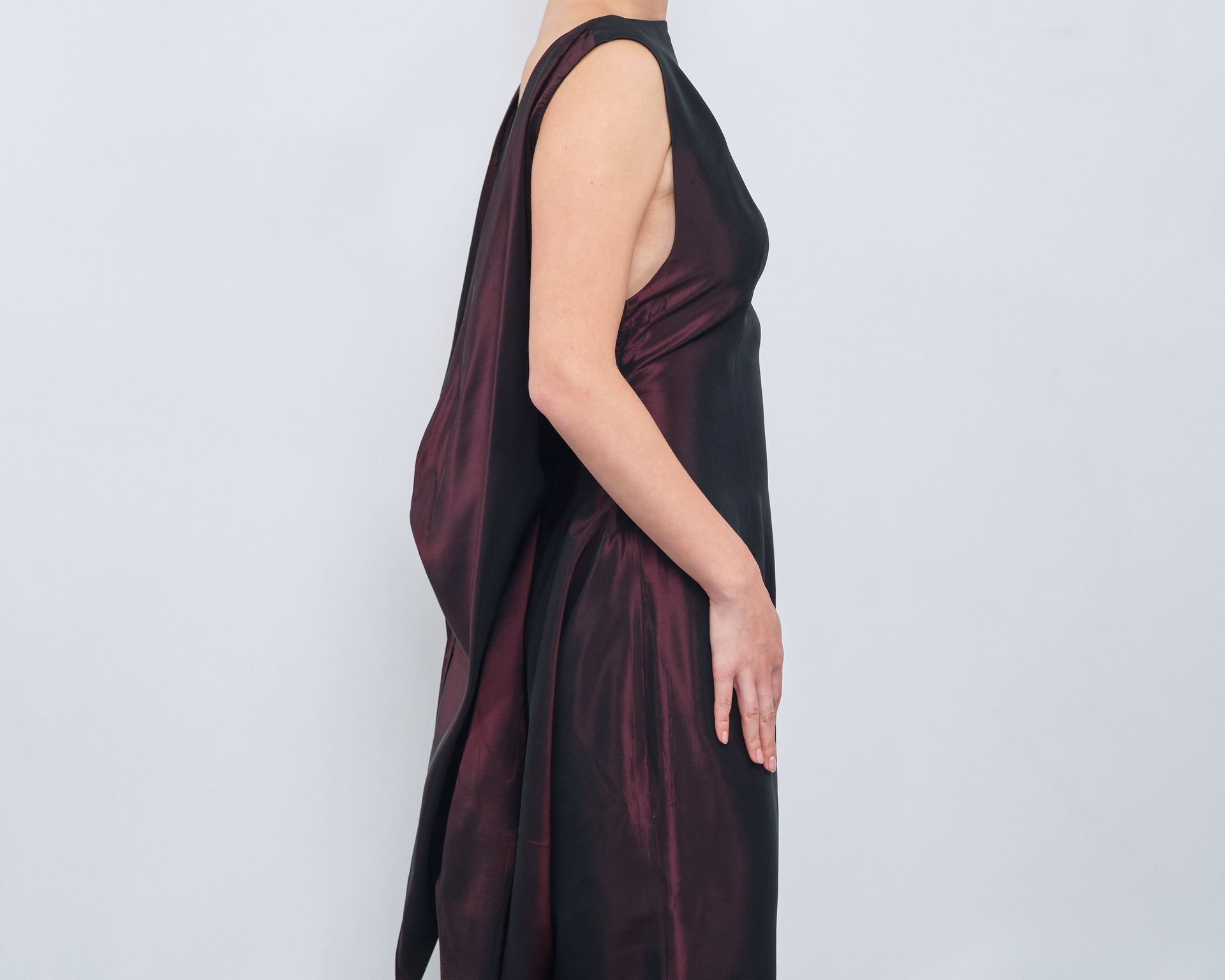 A woman is wearing a burgundy and black dress