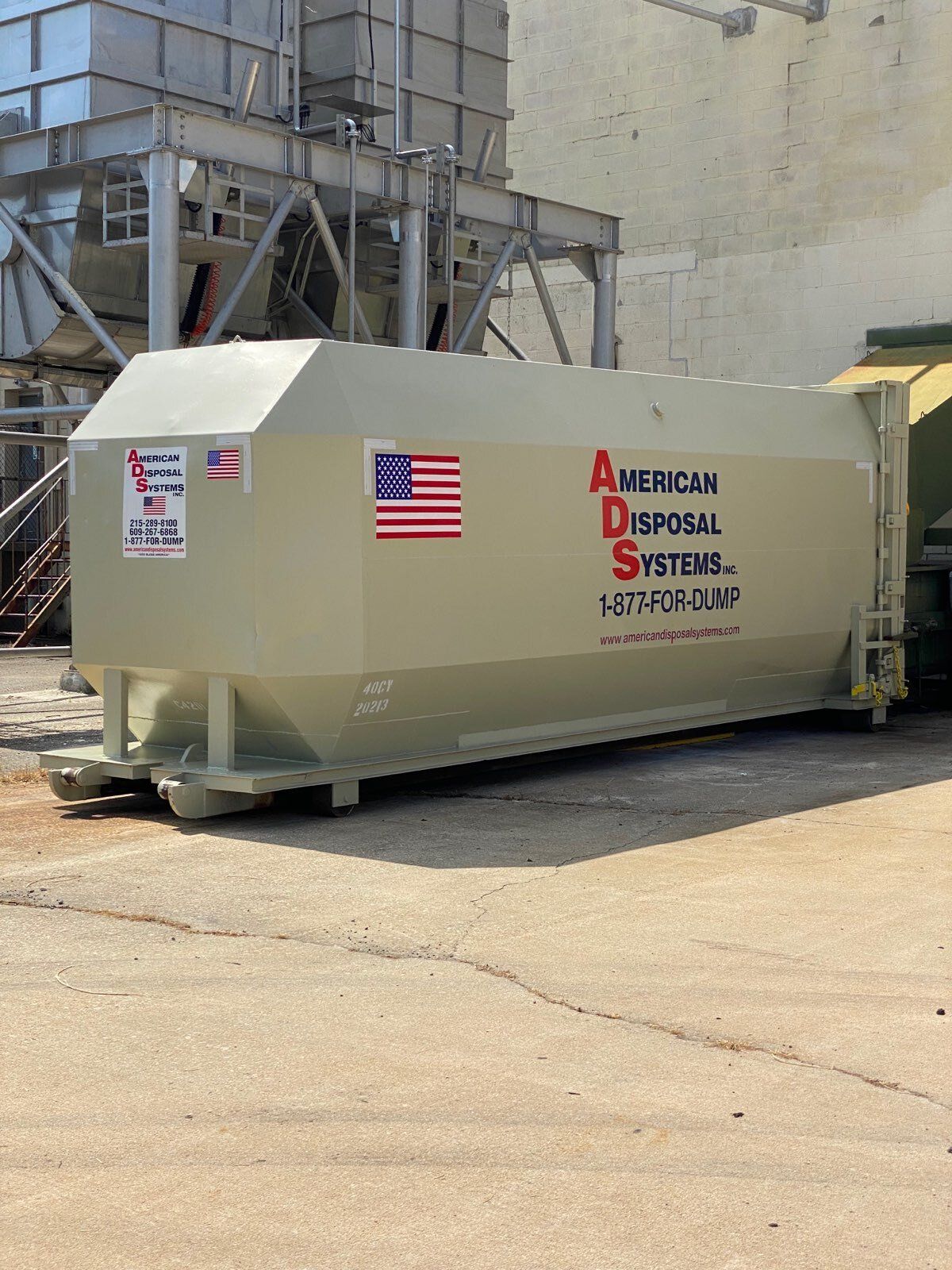 A commercial compactor at a large warehouse