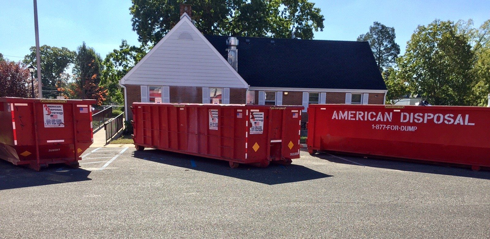 A thirty cubic yard dumpster is parked in the driveway of a home in Philadelphia, PA