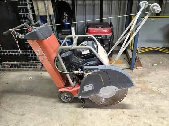 A concrete saw is sitting on the ground in a garage. — Upgrade Earthworks In South Kolan, QLD
