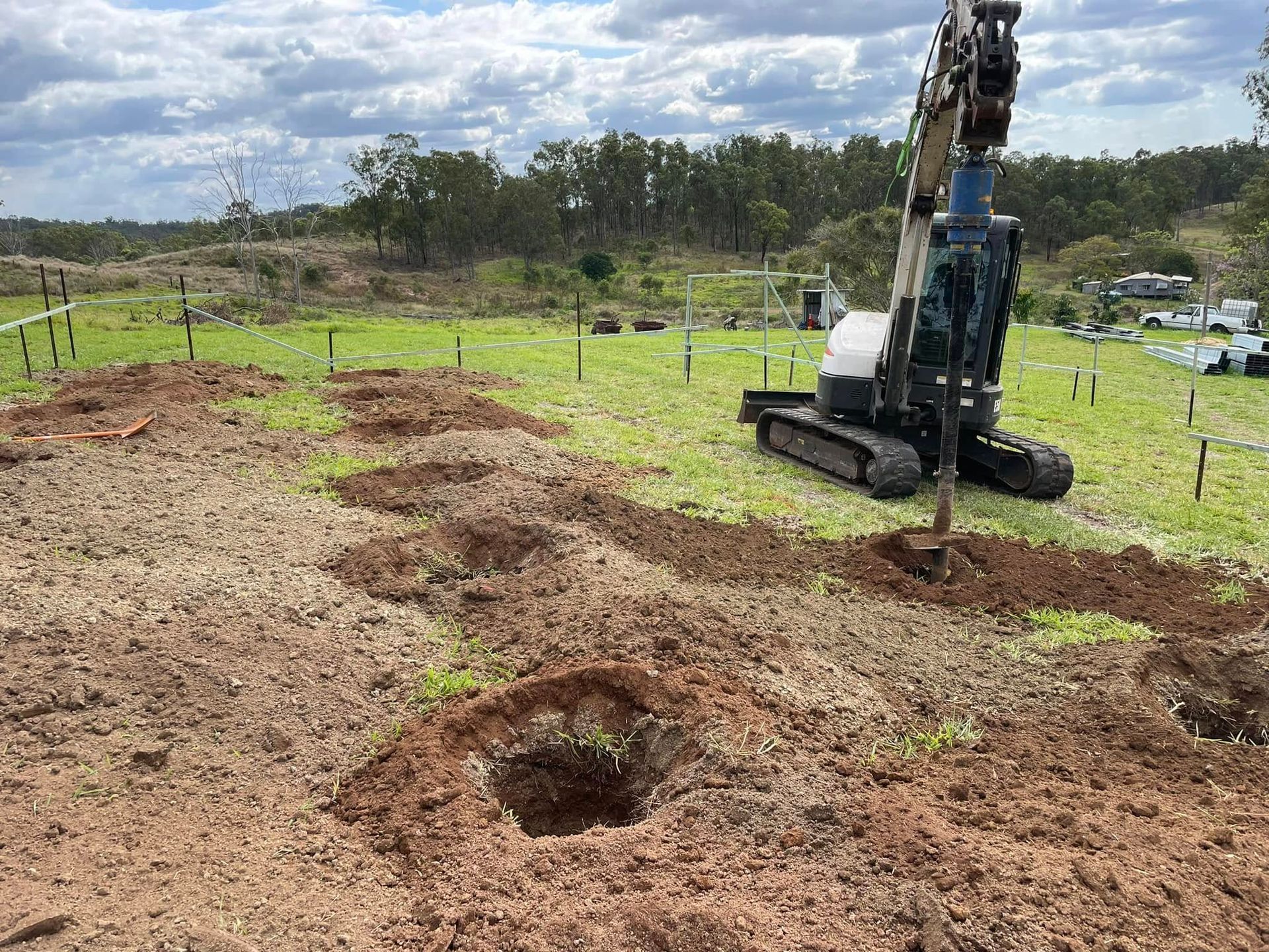 A bulldozer is digging holes in the ground in a field. — Upgrade Earthworks In South Kolan, QLD