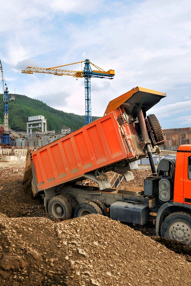 A Dump Truck Is Being Loaded With Dirt At A Construction Site — Upgrade Earthworks In South Kolan, QLD