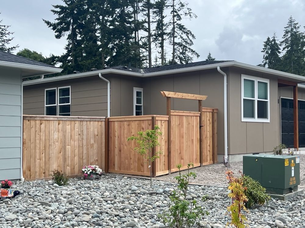 A house with a wooden fence in front of it