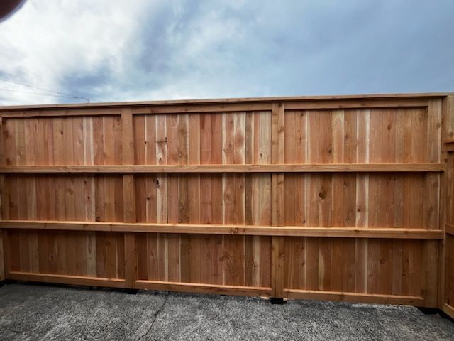 A wooden fence with a blue sky in the background