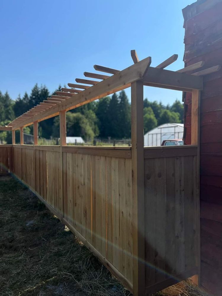 A wooden fence with a pergola attached to it.
