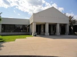Courthouse with white columns and sign: 