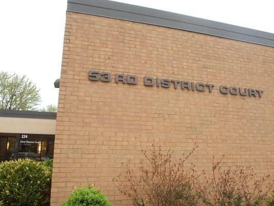 53rd District Court building exterior with brick walls and dark lettering.