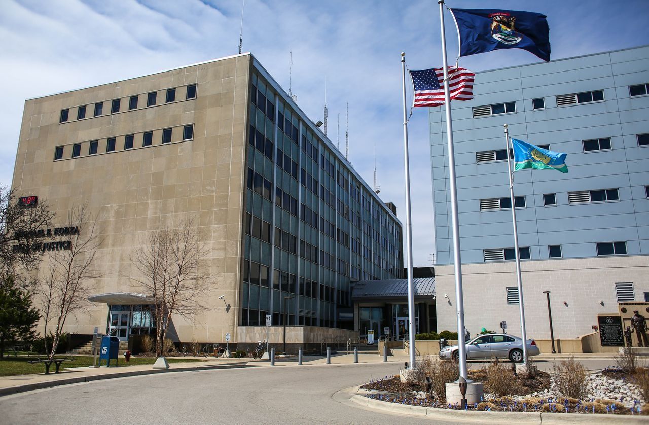 Large beige and blue office buildings with flags in front.
