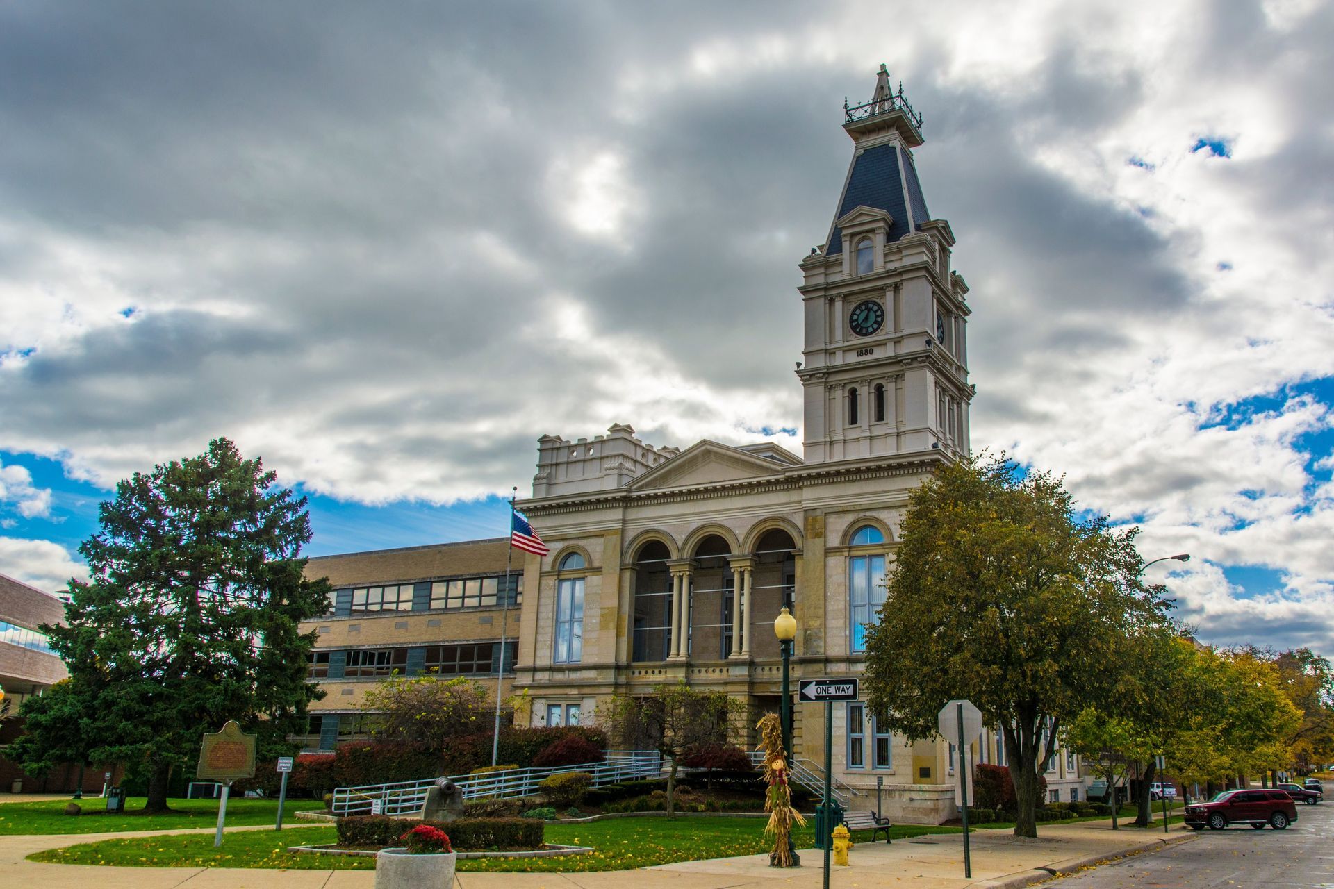 Historic courthouse building with clock tower under cloudy sky.