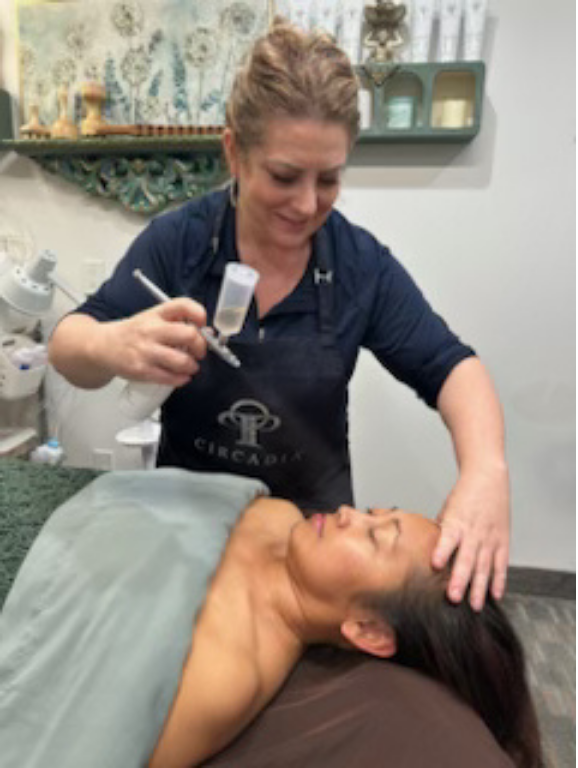 Hand in glove inserting acupuncture needles into skin.