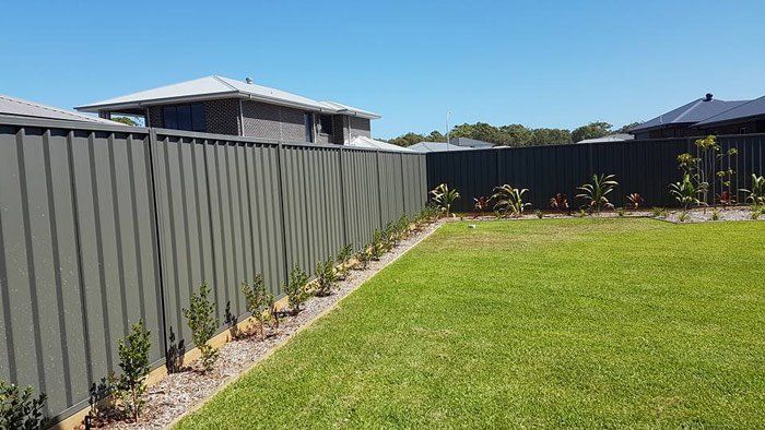 green color bond fencing with flower beds