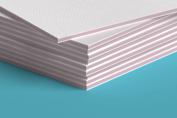 A close up of a stack of white sheets of paper on a blue surface.