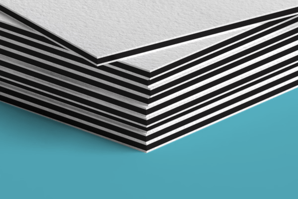 A close up of a stack of business cards on a blue surface.