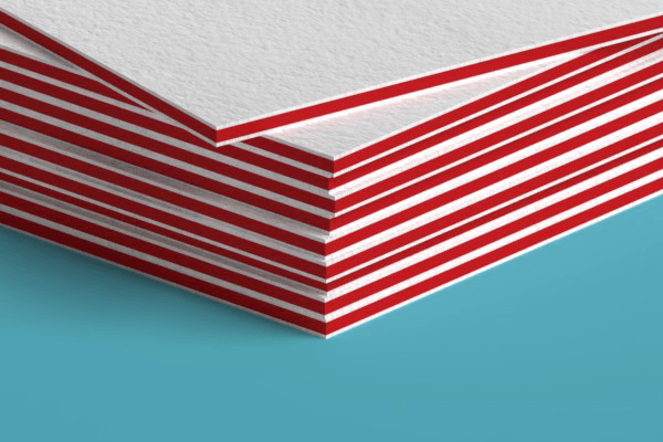 A close up of a stack of red and white business cards on a blue surface.