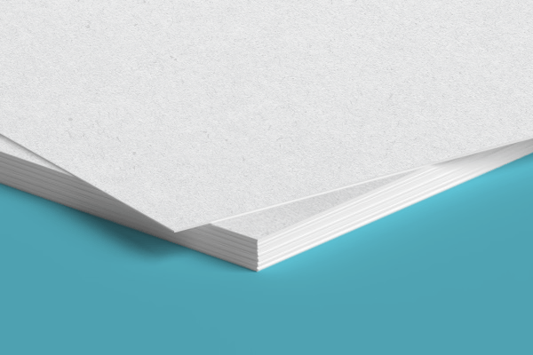 Two sheets of white paper are stacked on top of each other on a blue surface.