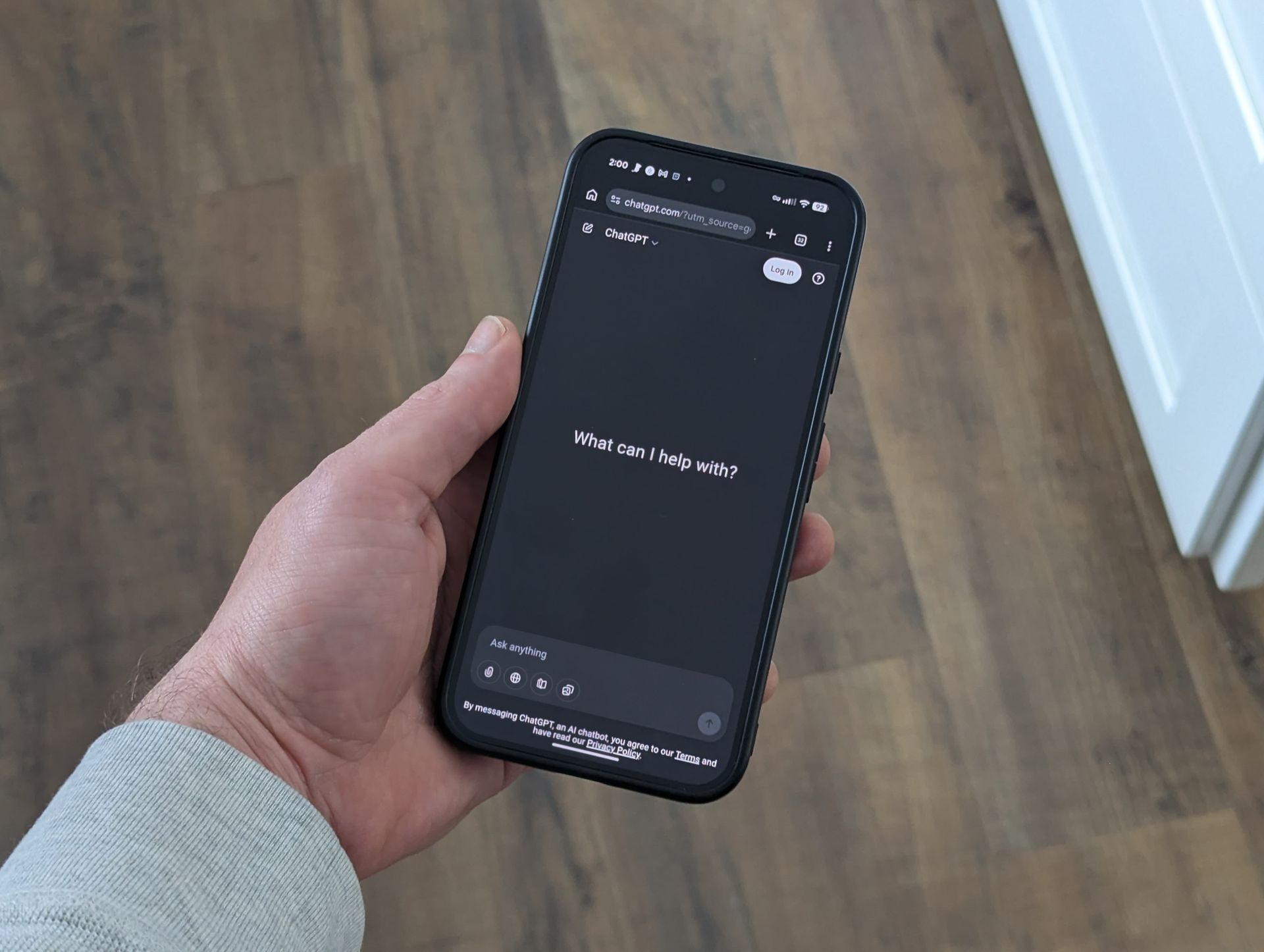 A person holding a phone displaying a Google search, with the text