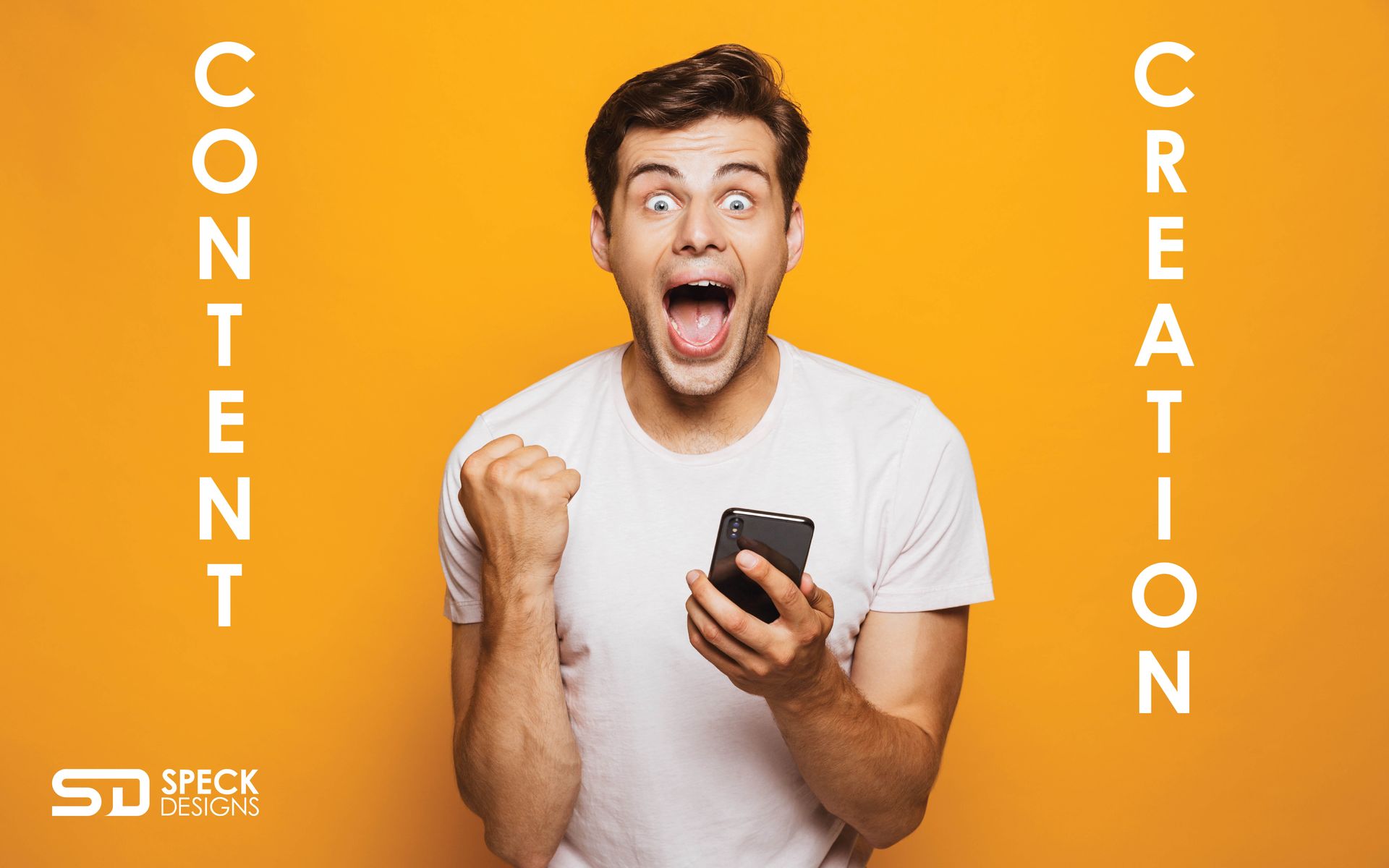 a man is holding a cell phone with his fist in the air in excitement.