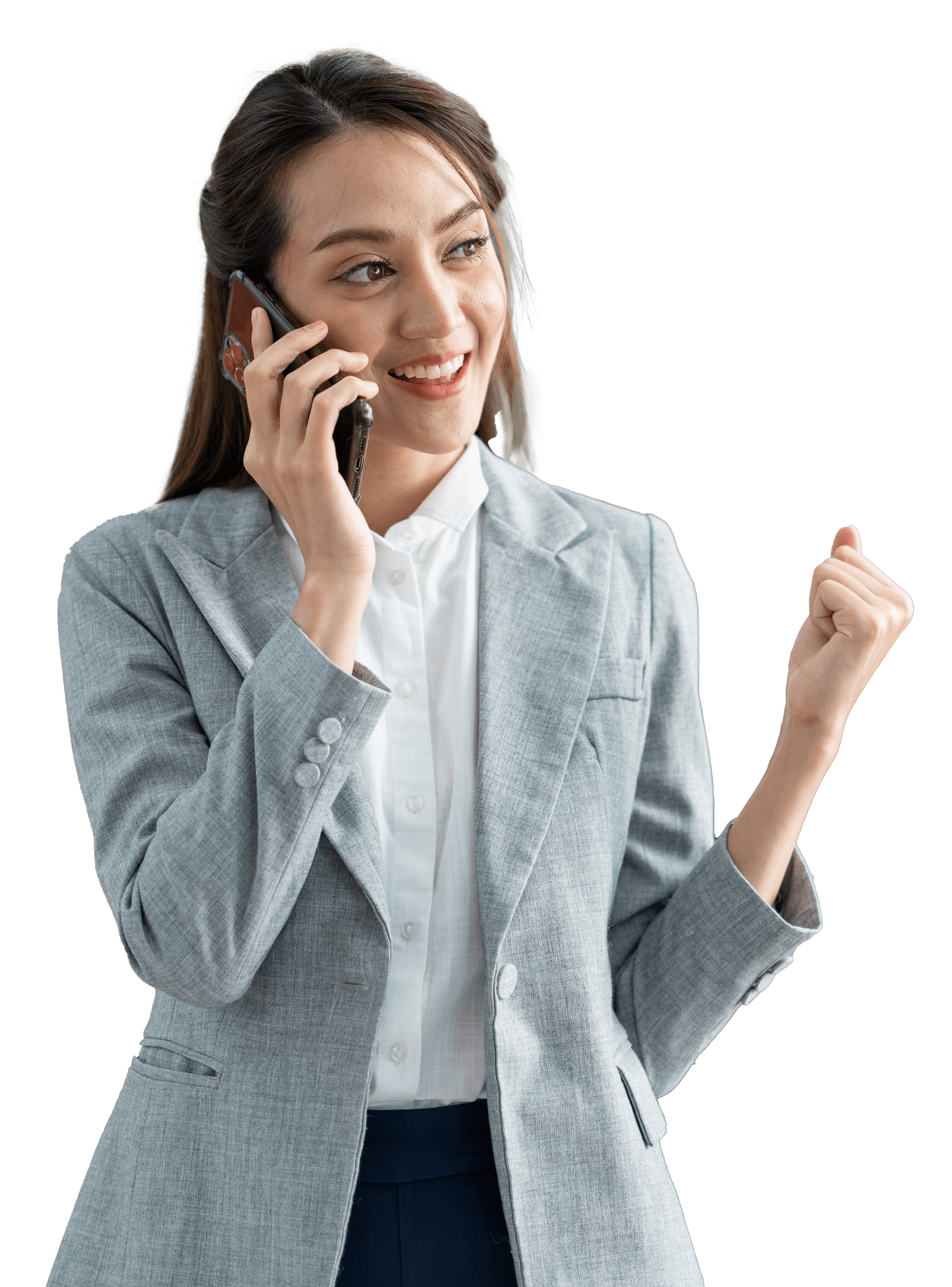 A woman in a suit is talking on a cell phone.