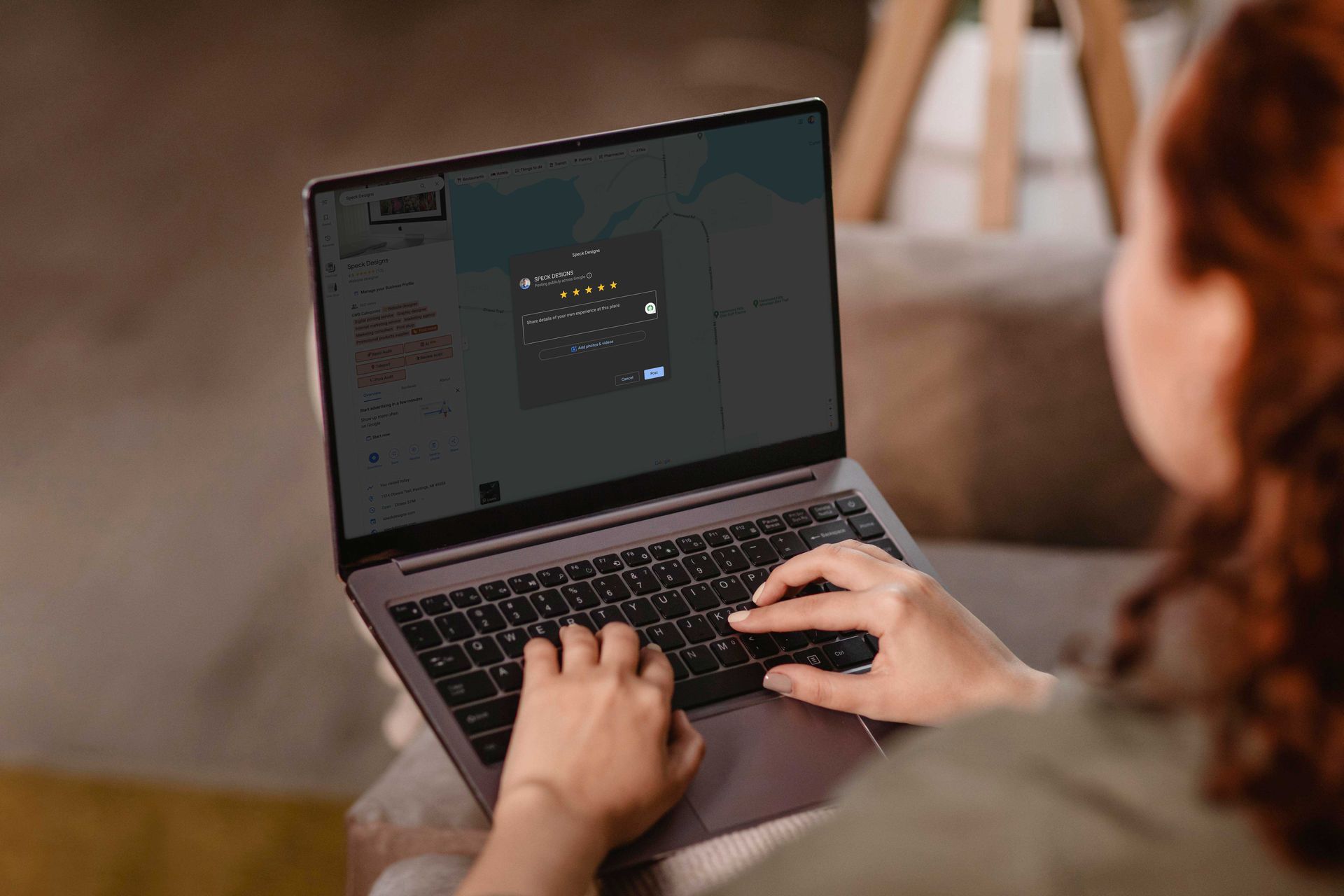 A woman using a laptop to leave a website design project review for Speck Designs, in Hastings MI