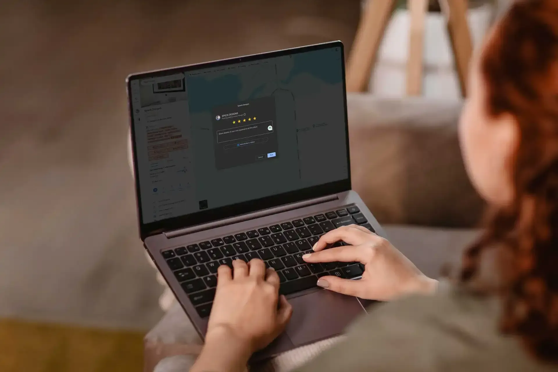 A woman using a laptop to leave a website design project review for Speck Designs, in Hastings MI