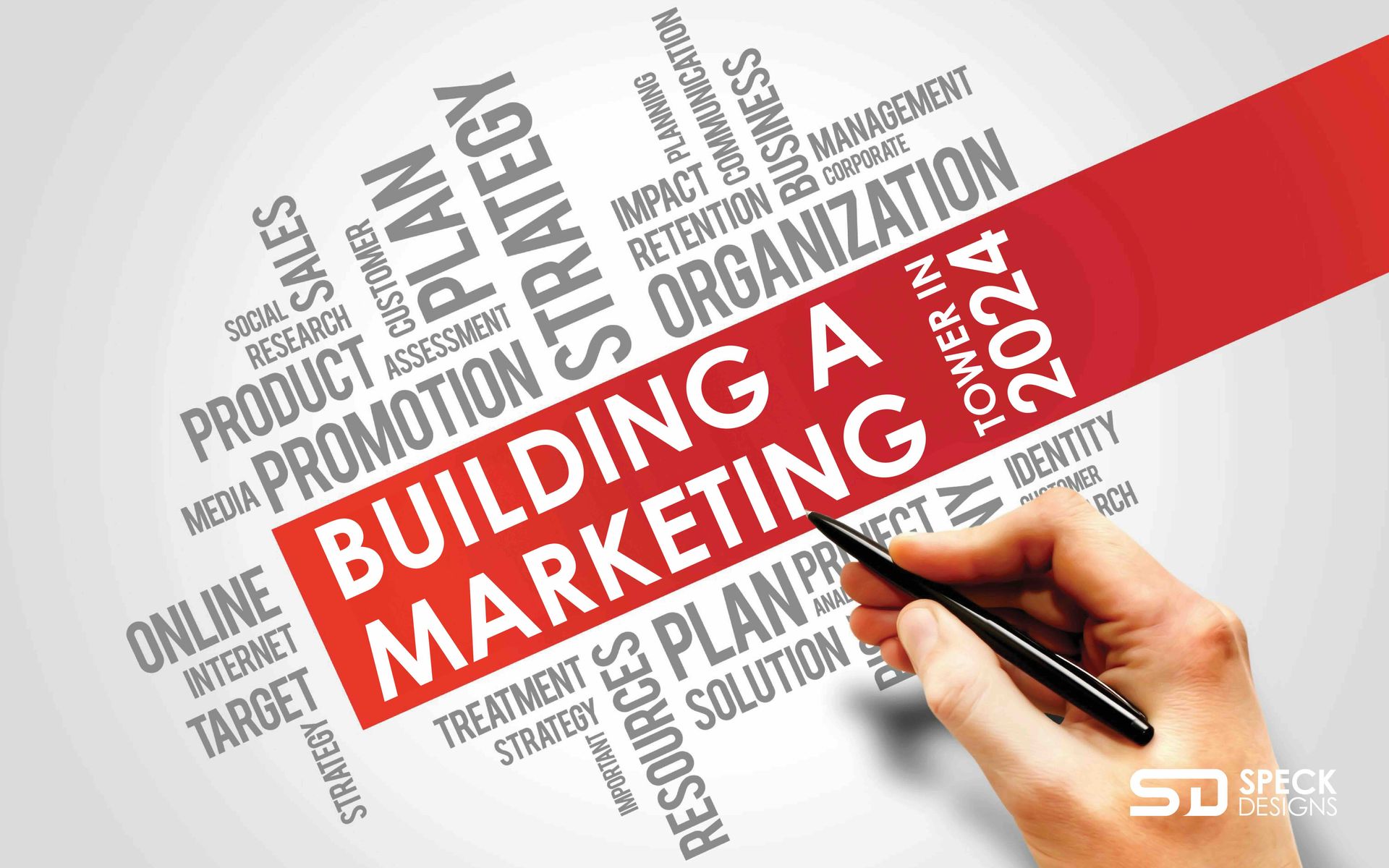 A person is writing the word building a marketing plan on a piece of paper.