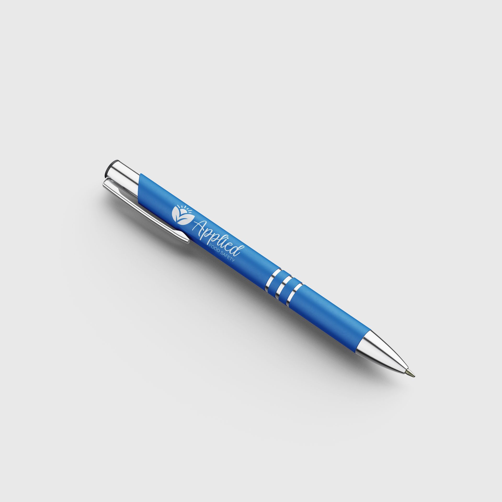 A blue pen with the logo Applied Food Safety on it is sitting on a light gray surface.