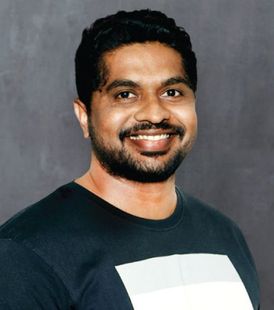 Saurabh, the SEO manager of Speck Designs, is smiling for the camera.