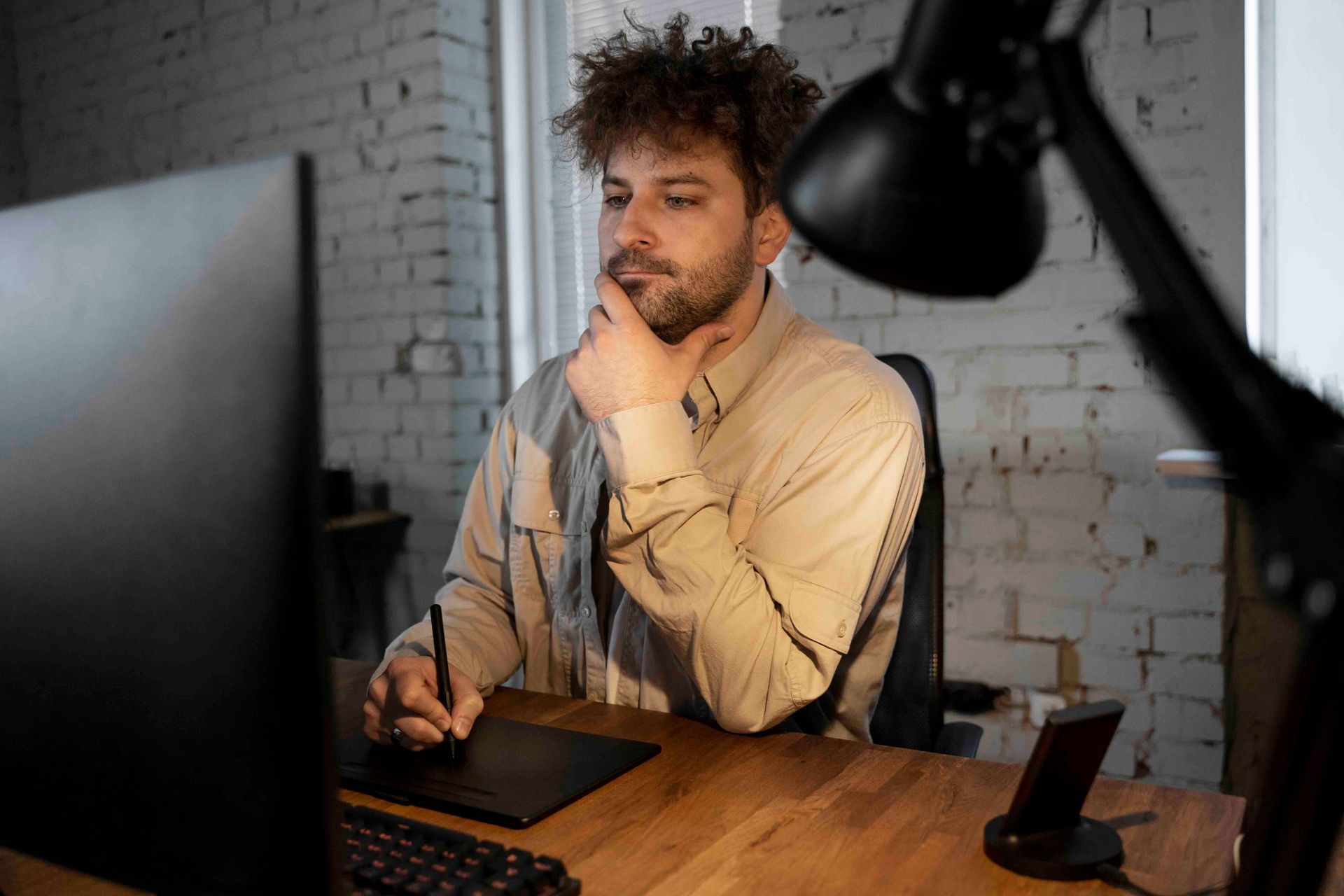 A man is sitting at a desk in front of a computer.