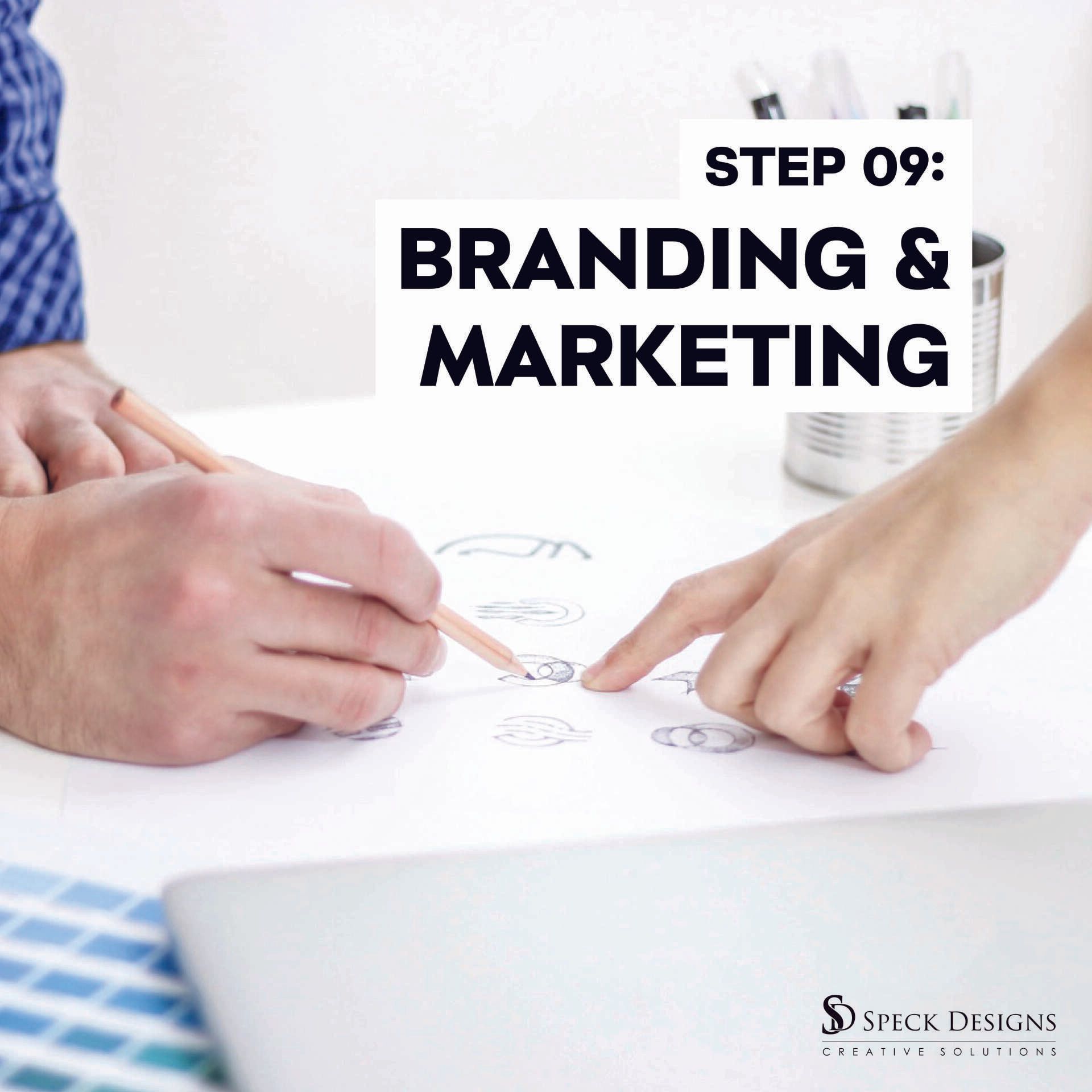 A man and a woman are sitting at a table looking at a piece of paper