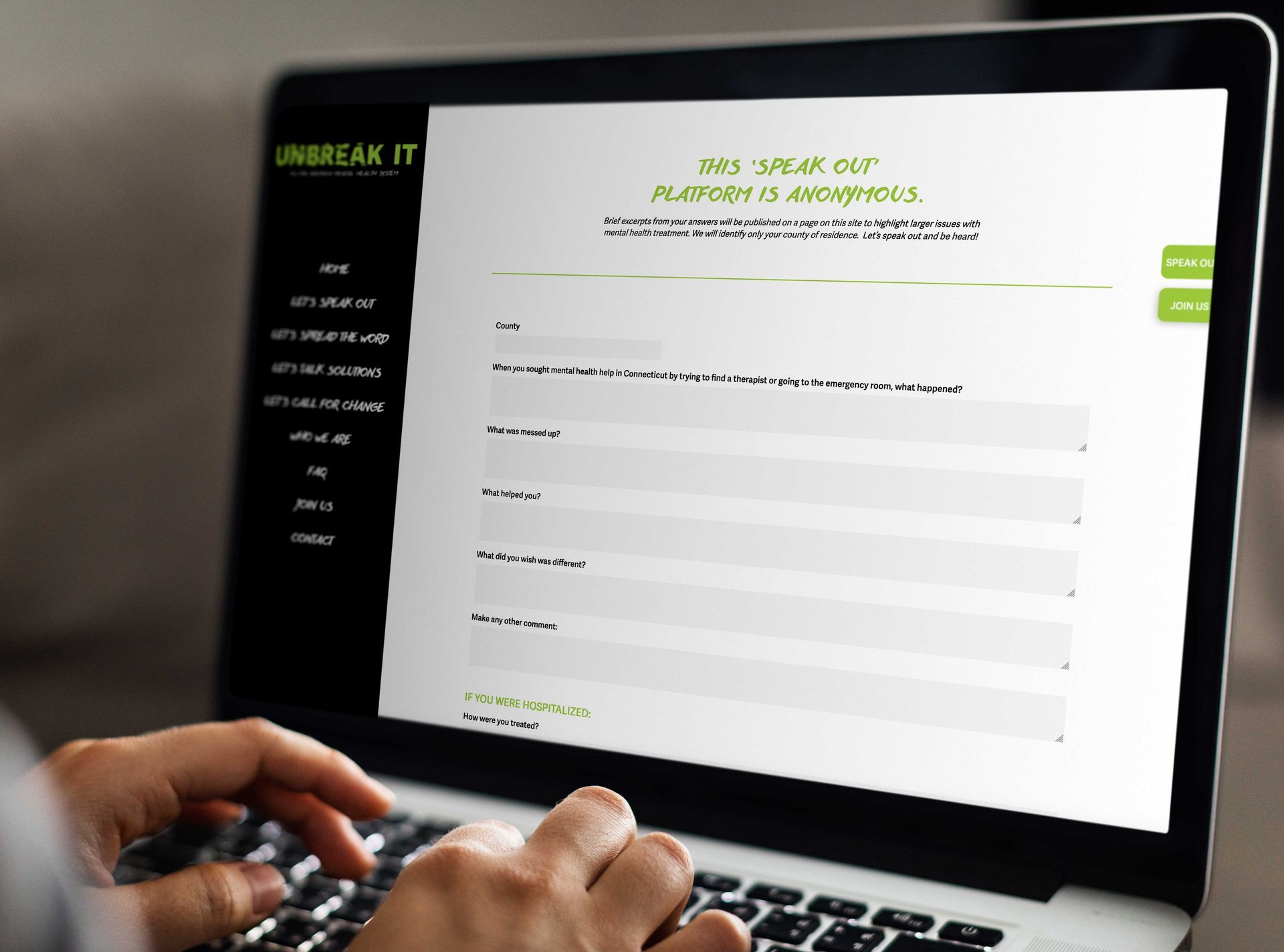 A person is typing on a laptop that says UNBREAK IT on it.