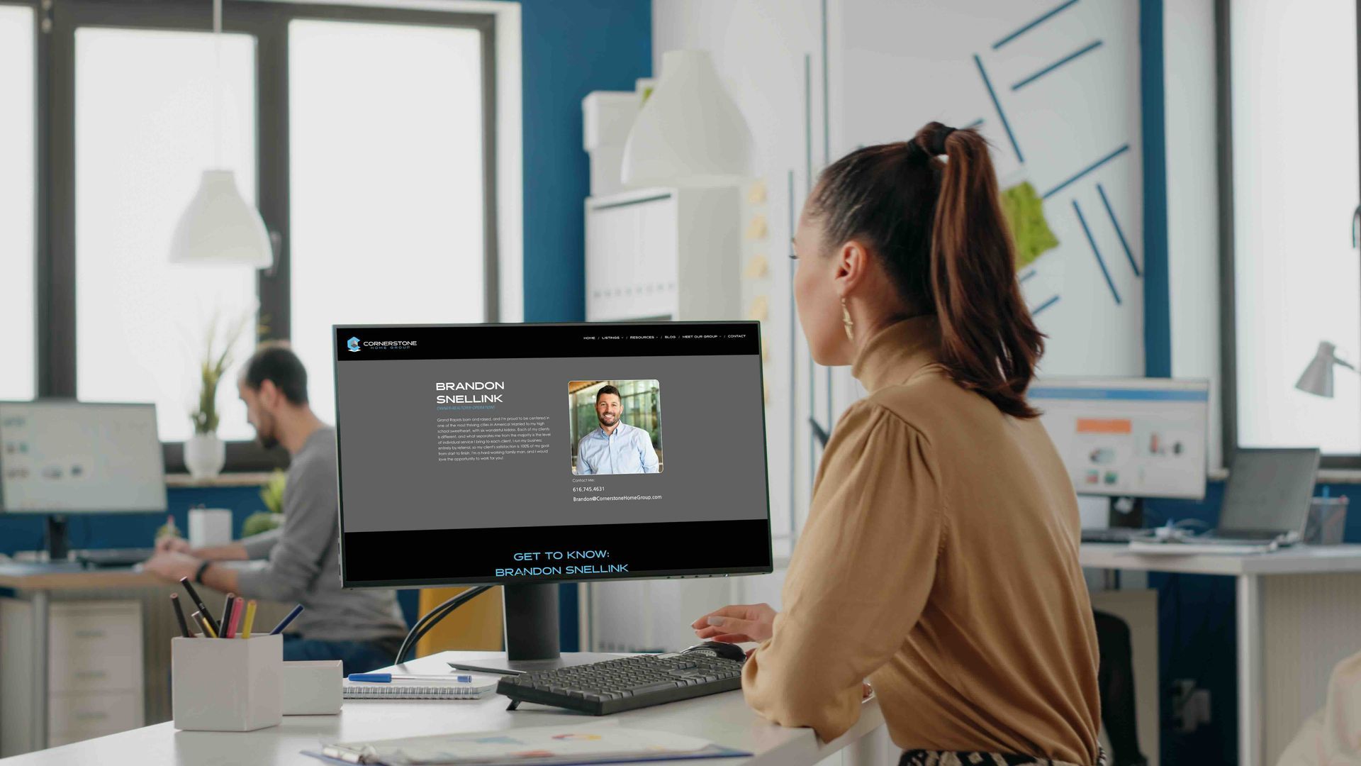 A woman is on a website looking at Brandon Snellink's agent page on the Cornerstoen Home Group's website.