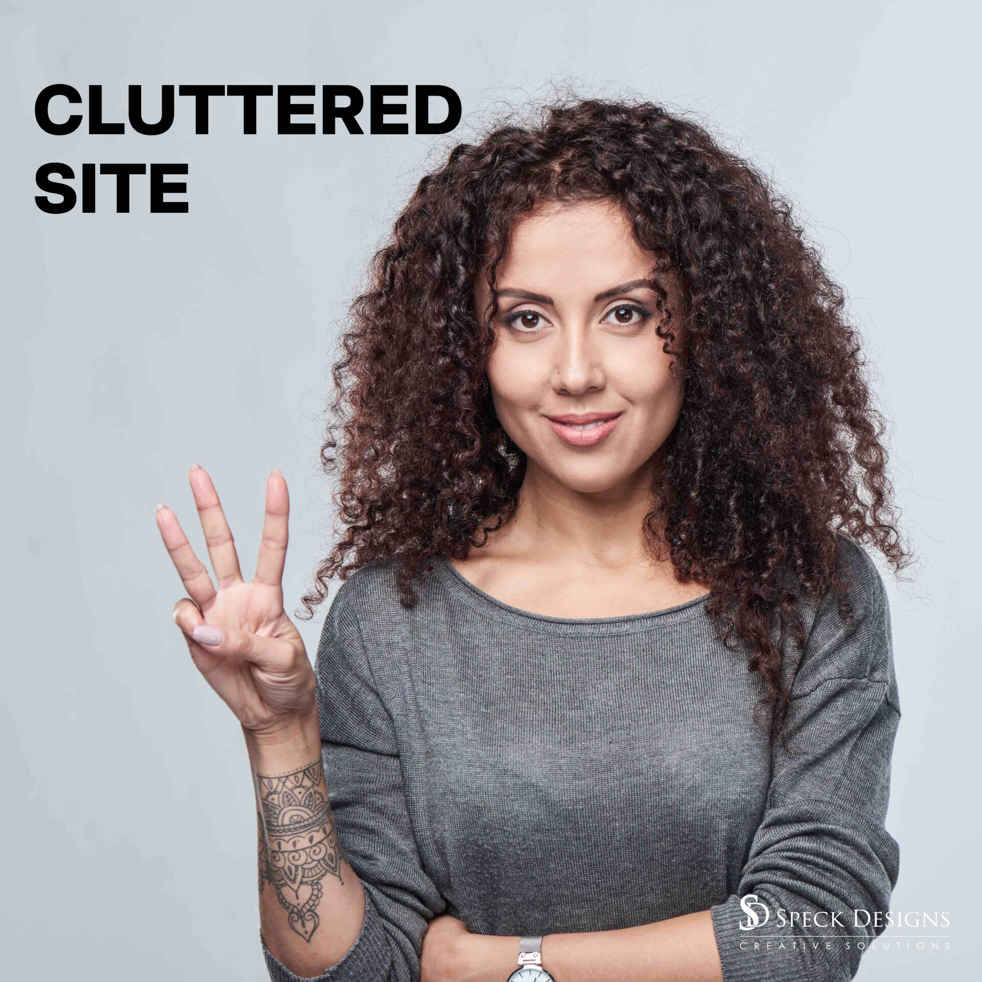 A woman with curly hair is giving a peace sign.