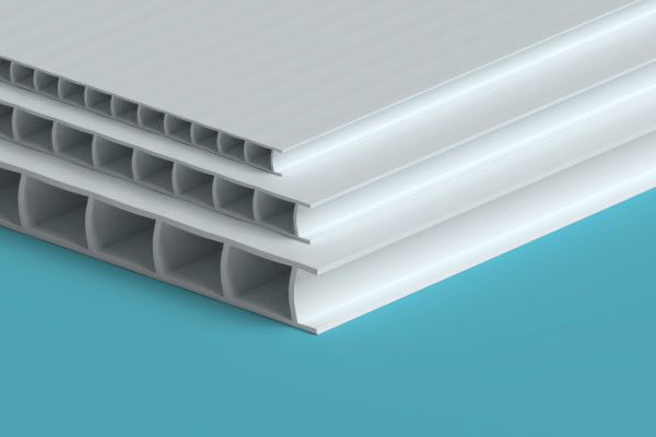 Three white sheets of plastic are stacked on top of each other on a blue surface.